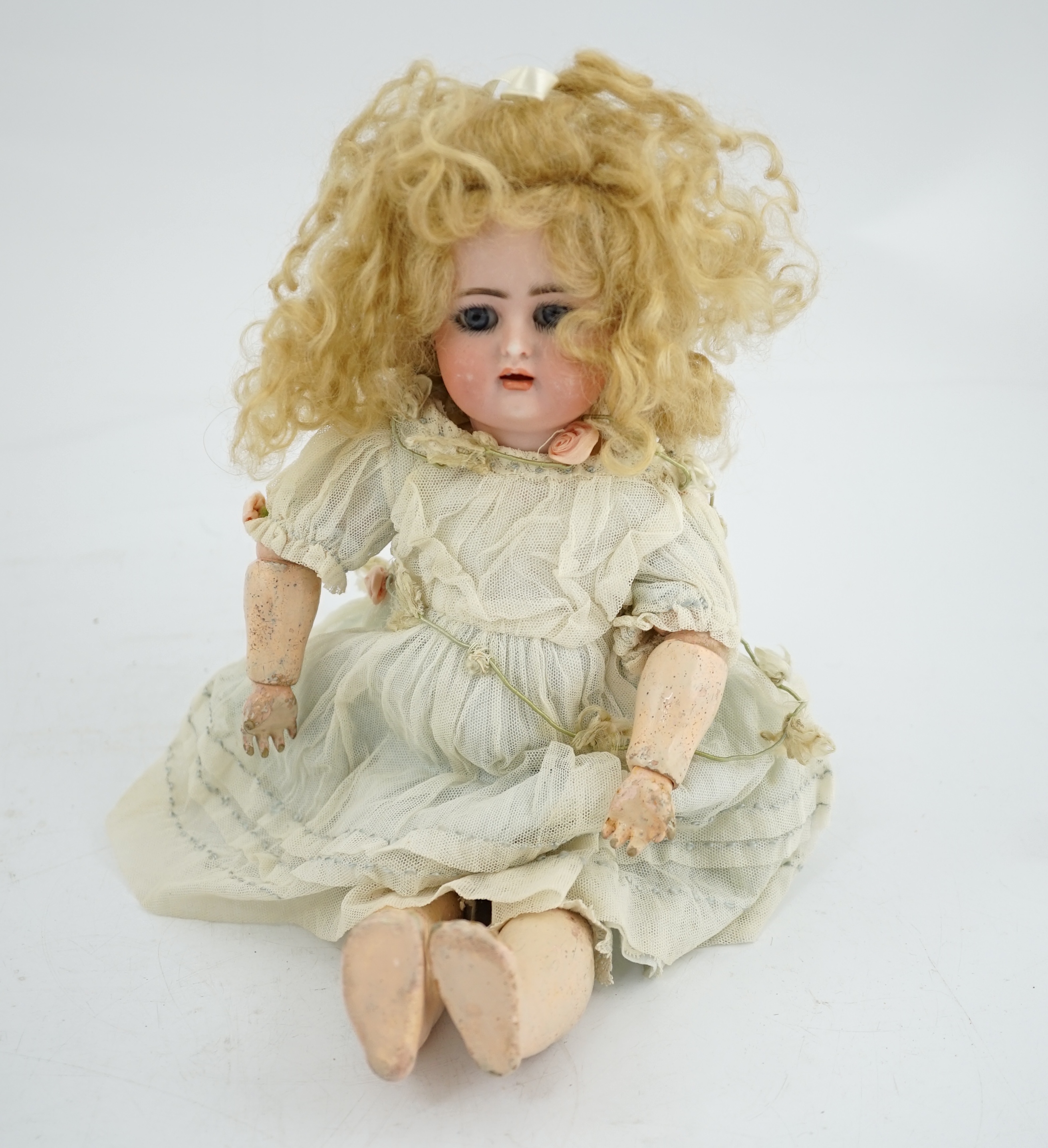 A Kammer & Reinhart / S & H bisque head doll, pierced ears, vintage clothes, one finger missing, slight rub to robe, 34cm
